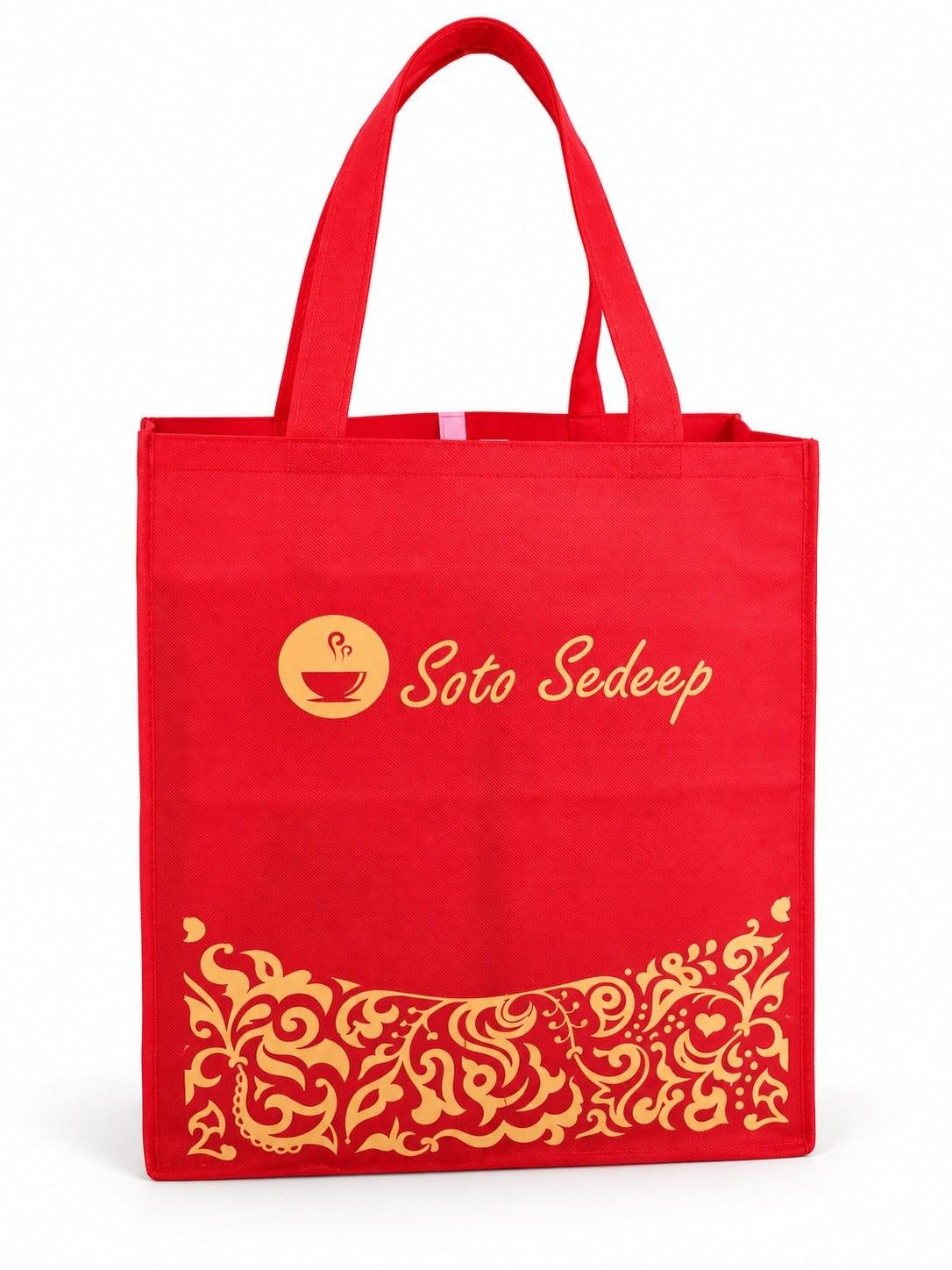Tas spunbond merah dengan sablon emas dan motif hias