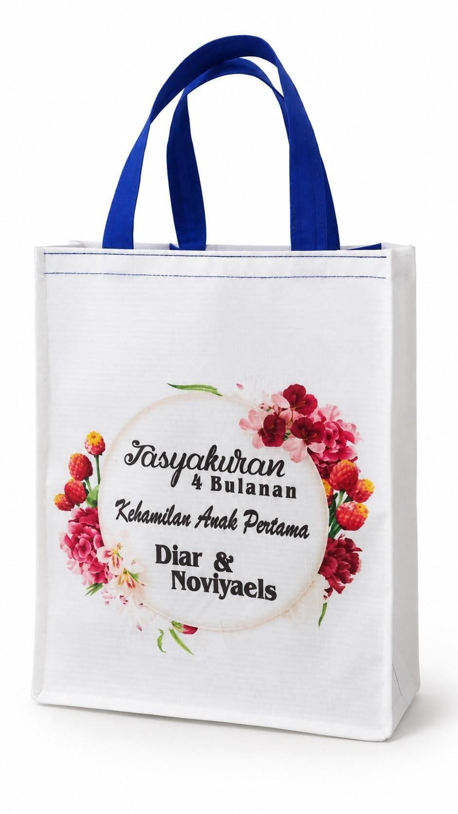 Tas spunbond putih dengan tali biru dan cetak warna bermotif bunga
